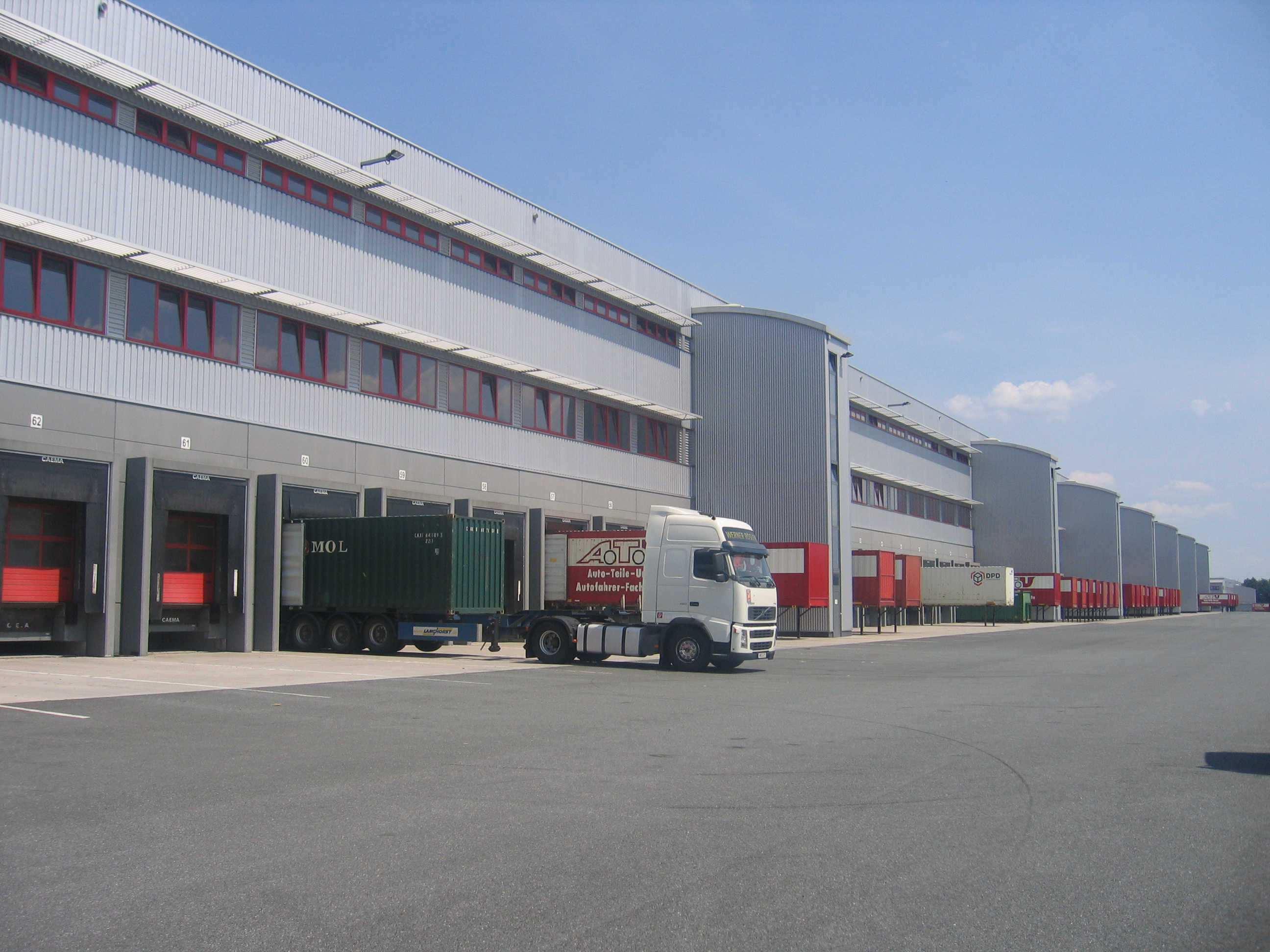 Werl - Exterior of warehouse viewing the loading bays with trucks parked