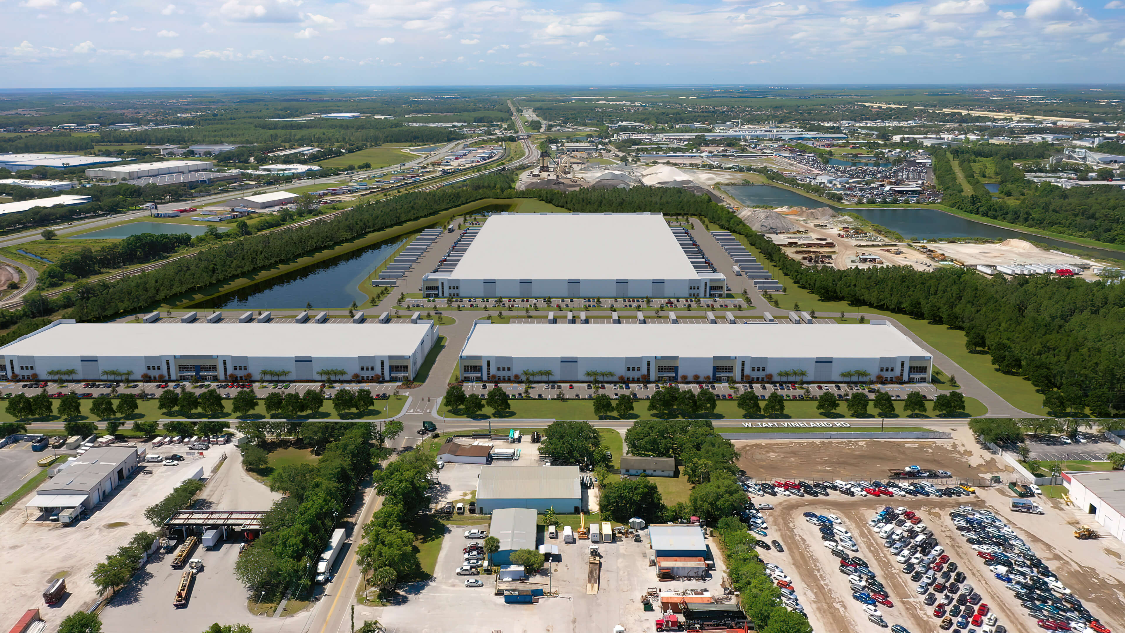 McCoy Field Logistics Center - bird's eye view of logistics park with 3 white buildings and neighboring buildings