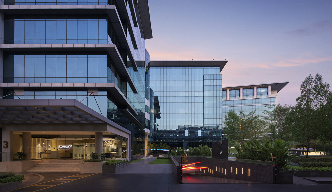 Equinox office building at dusk and ramp to underground parking
