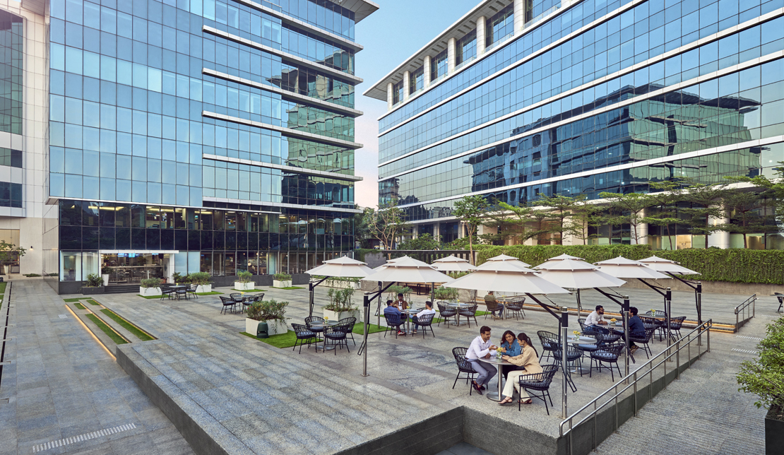 Equinox center courtyard with people gathering at tables