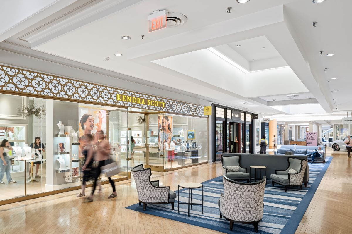 interior of shopping center showing storefronts of Kendra Scott and Coach