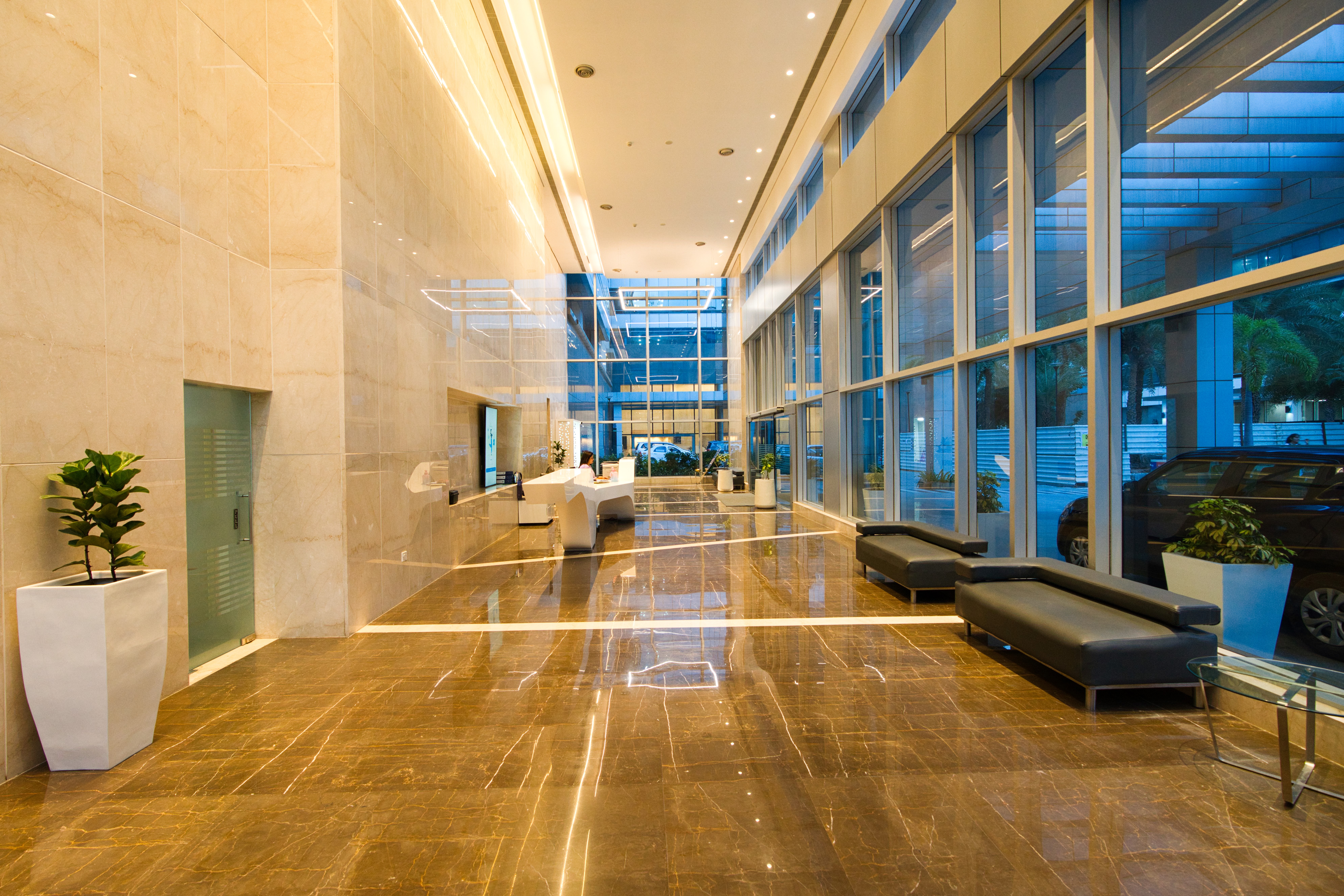 Lobby corridor at dusk with soft seating benches