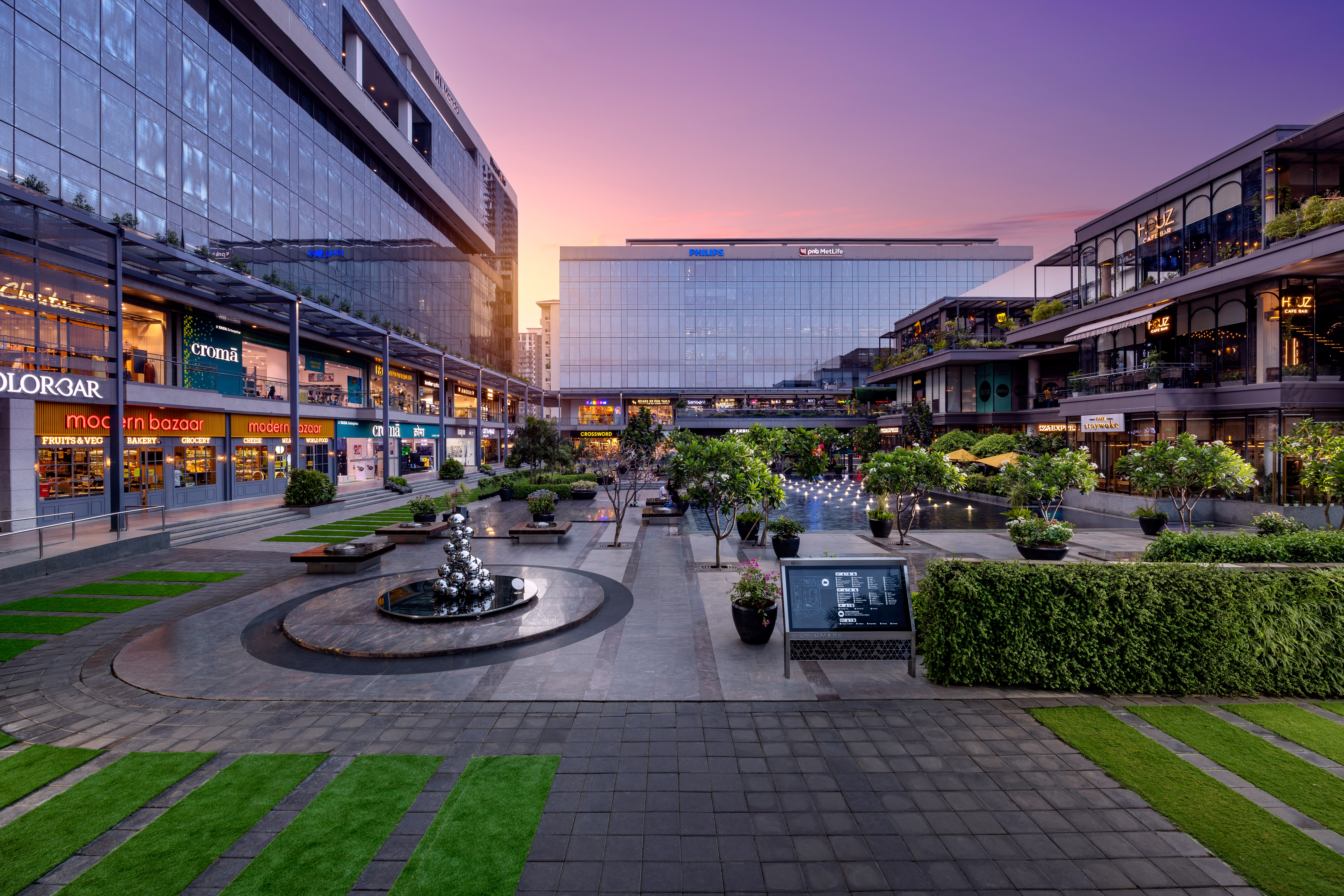 Courtyard with surrounding retail at dusk