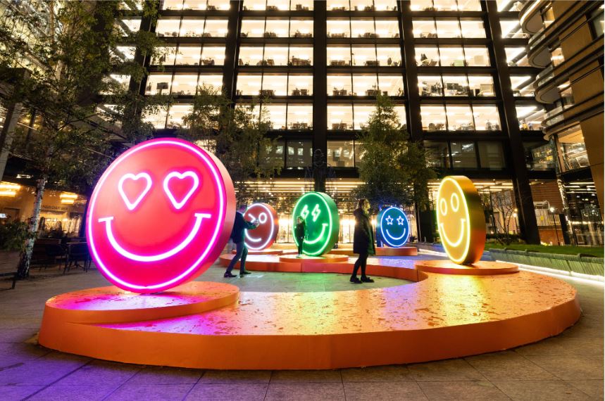 sculptures of smiley faces made with neon