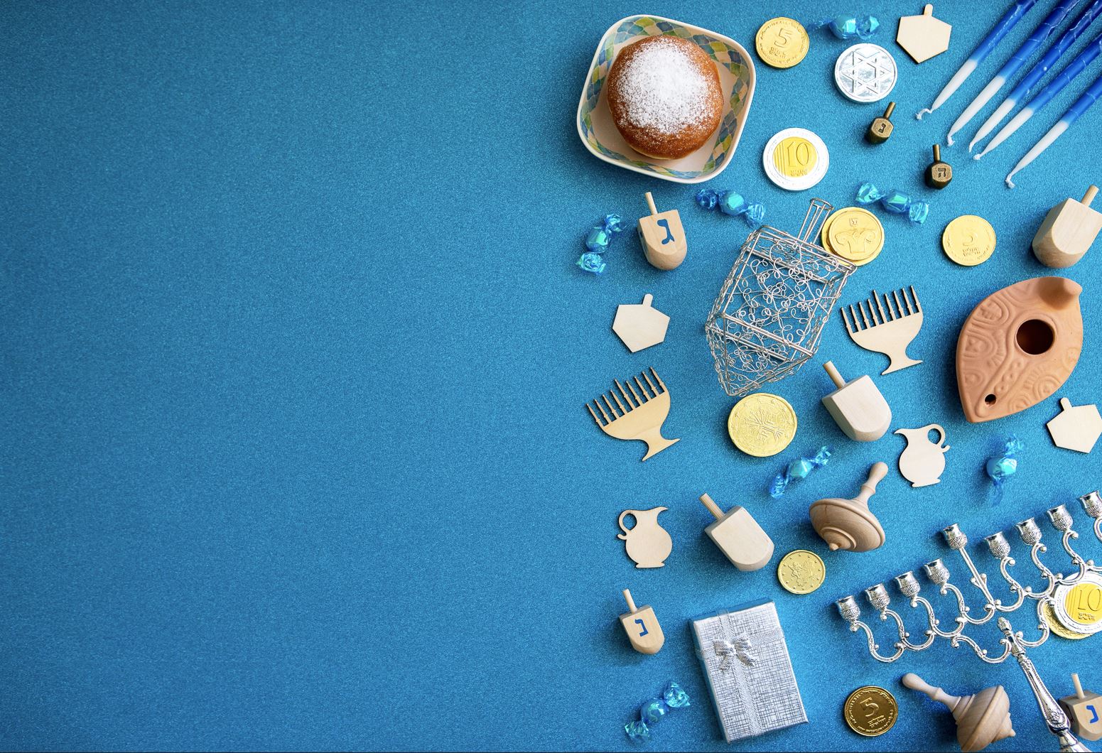 Hanukkah items on a blue background
