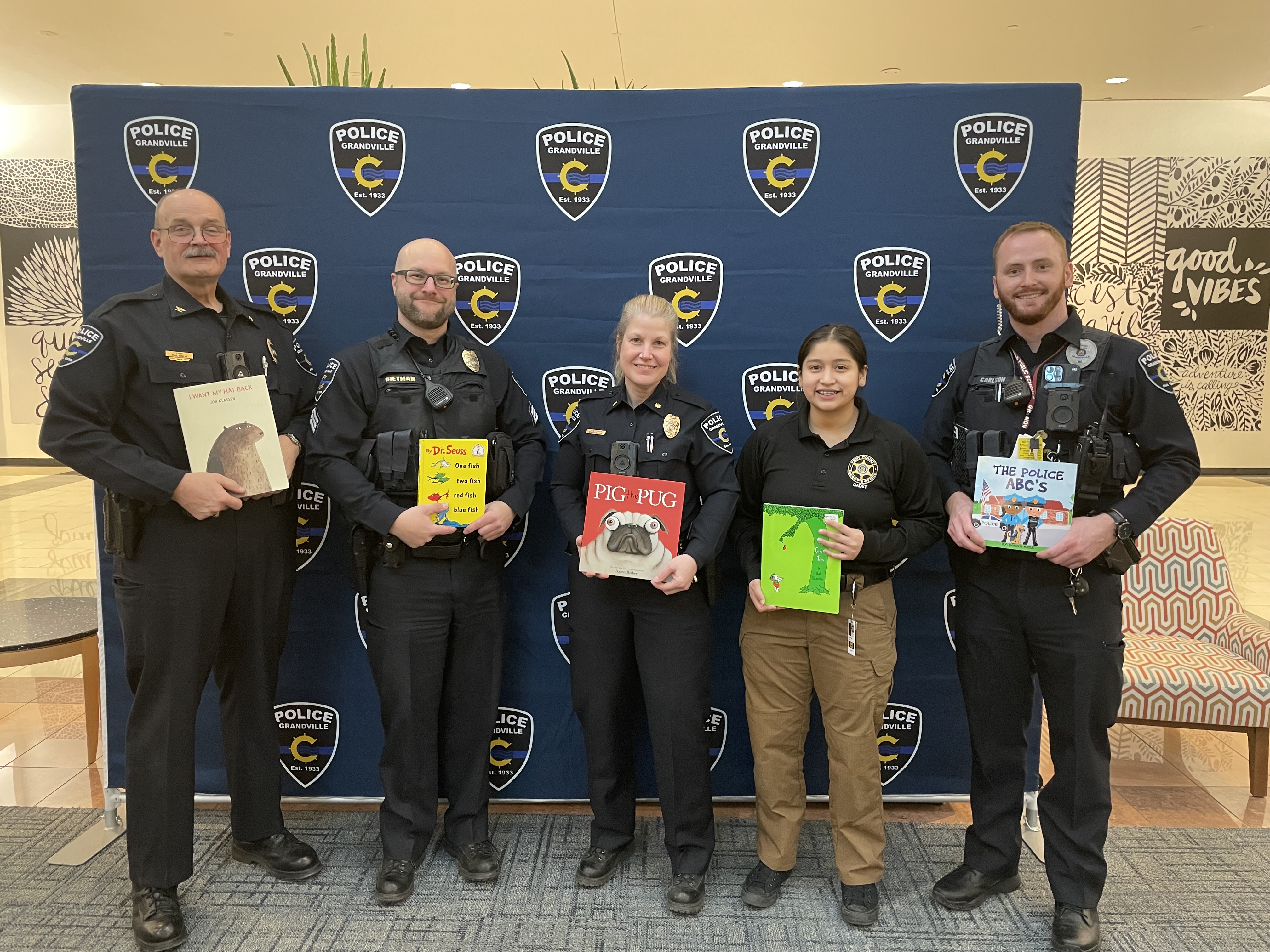 Police officers holding books